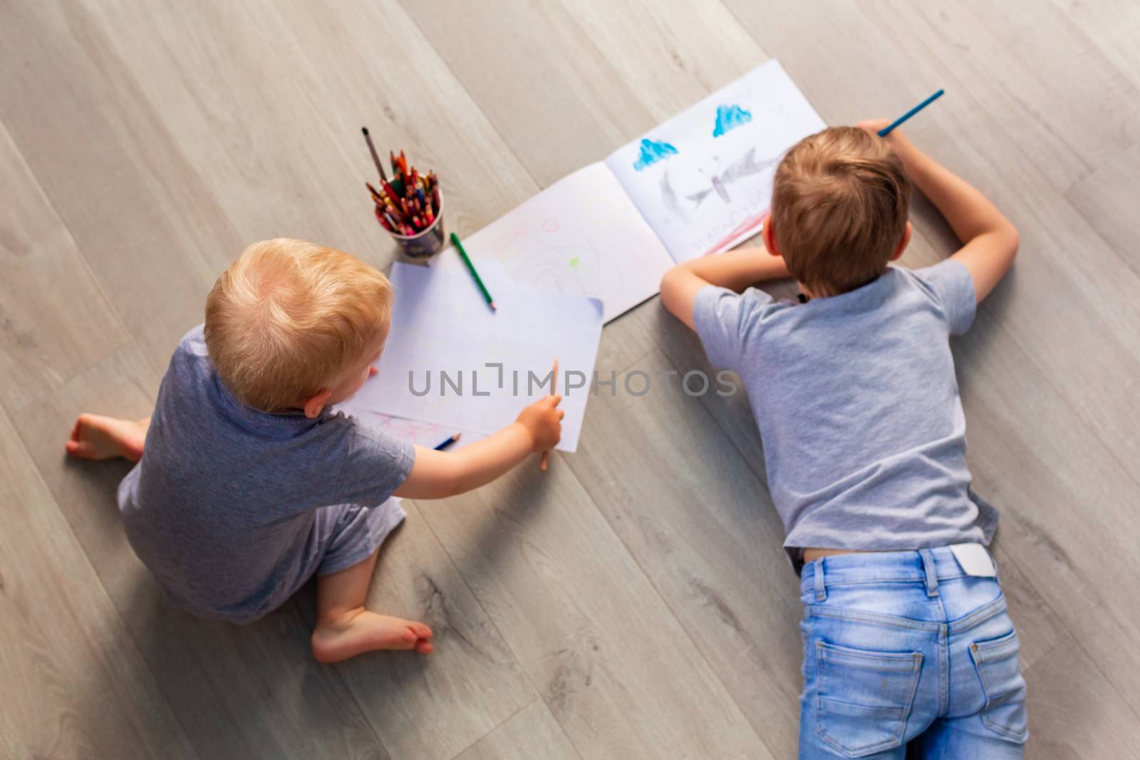 Two little boys drawing on the floor in his room by Len44ik