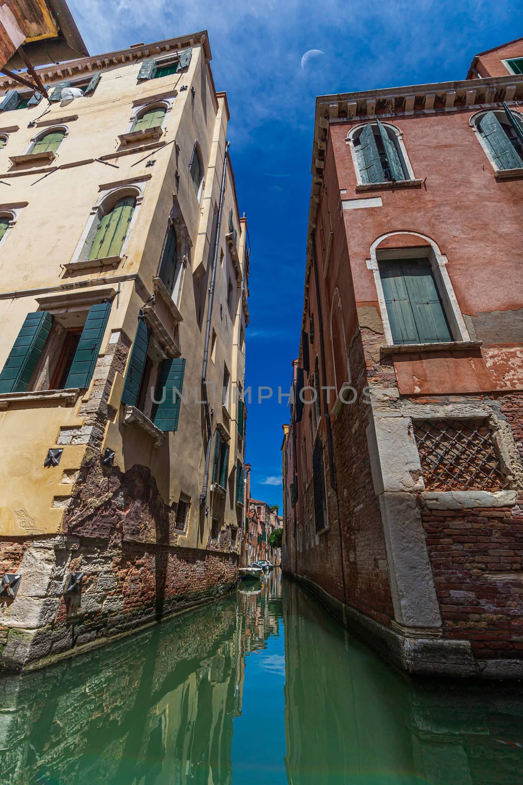 Narrow canal among old brick houses in Venice, Italy by COffe