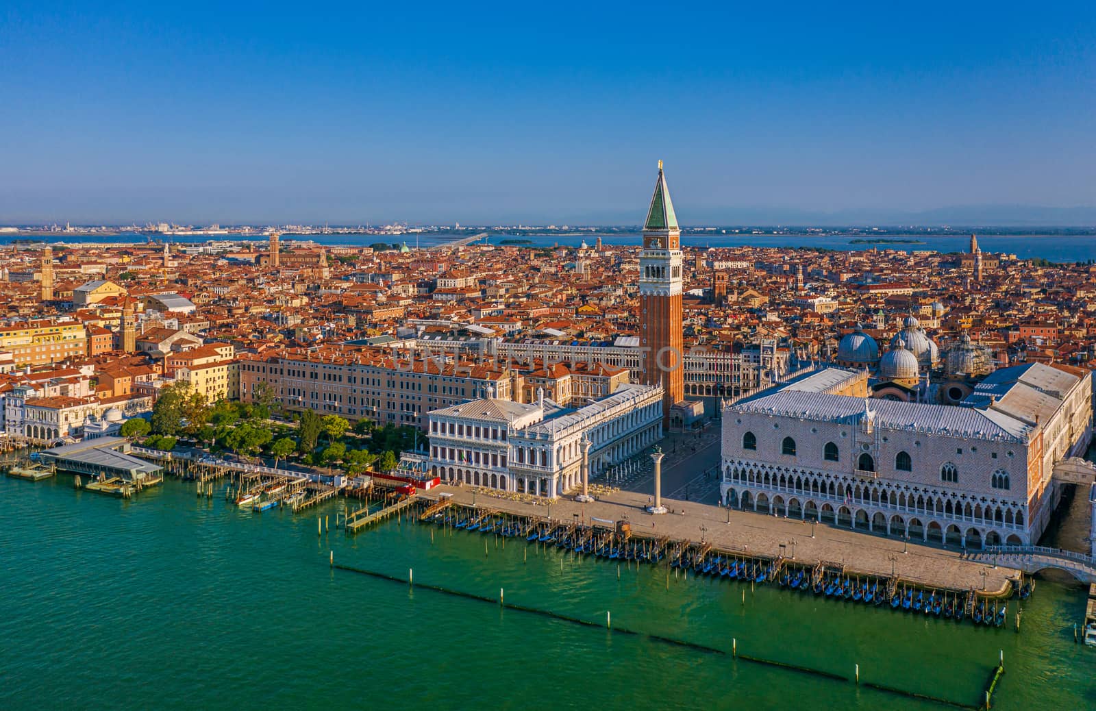 The famous San Marco Campanile and the Doges Palace in front of the Grand Canal in Venice on sunny day in north Italy