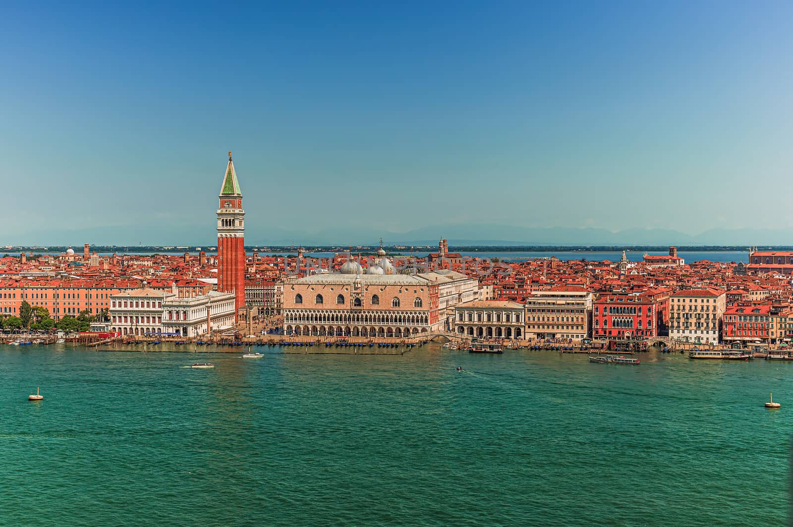 The famous San Marco Campanile and the Doges Palace in front of the Grand Canal in Venice on sunny day in north Italy
