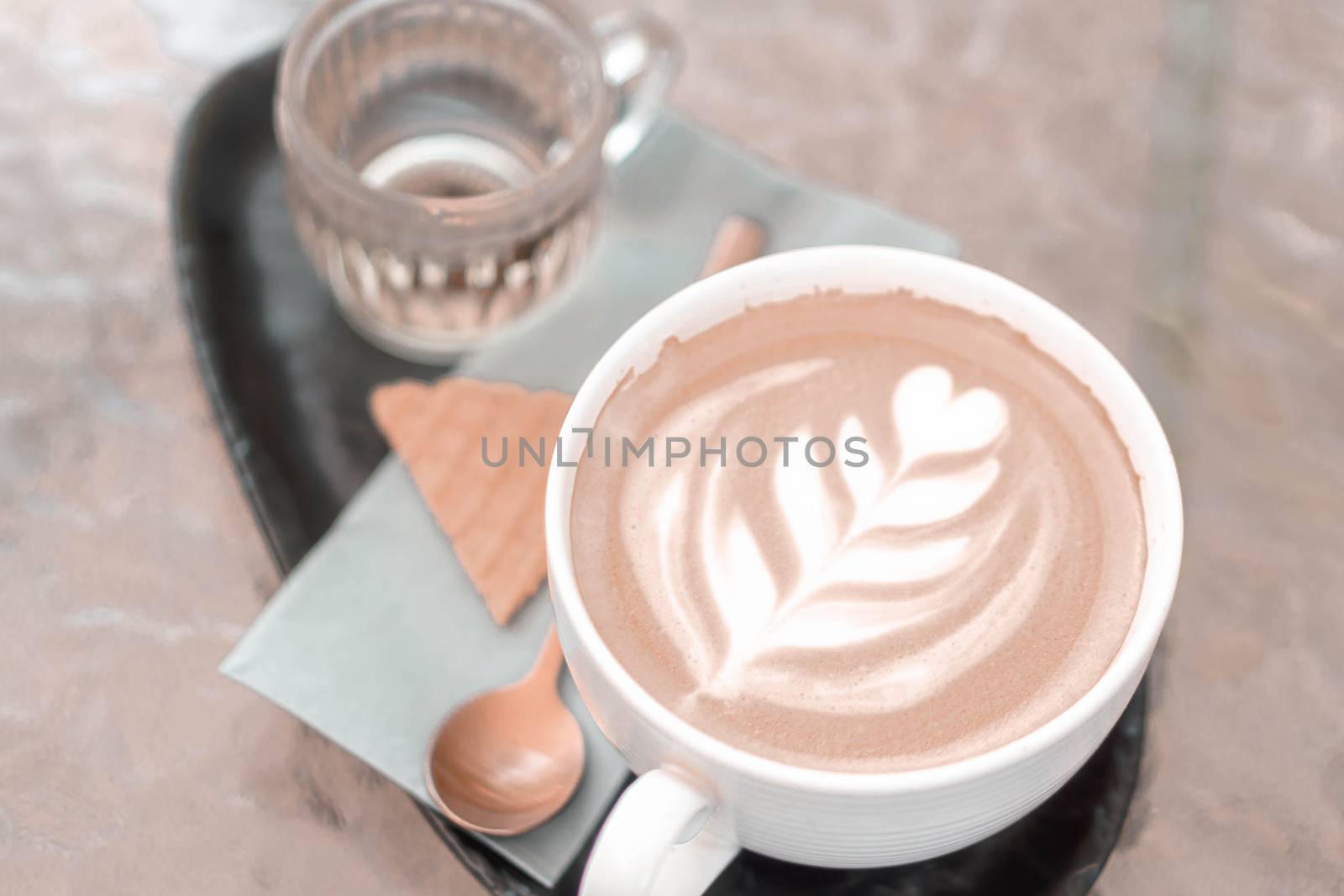 Closeup glass of latte art coffee tulip shape on wood background by pt.pongsak@gmail.com
