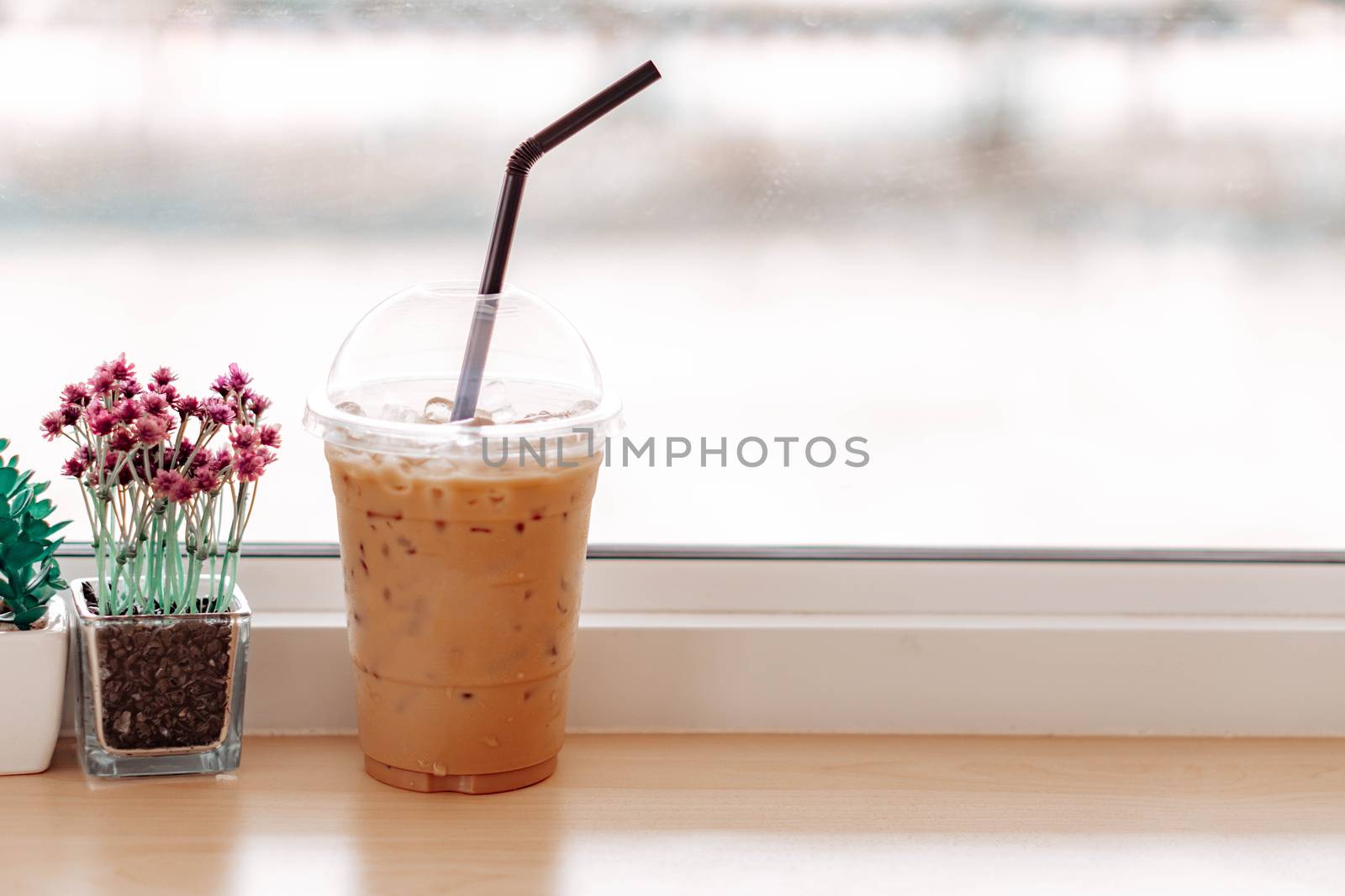 Close up glass of ice americano coffee on wood table, selective focus