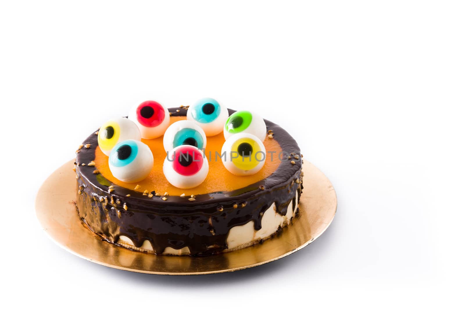 Halloween cake with candy eyes decoration isolated on white background.