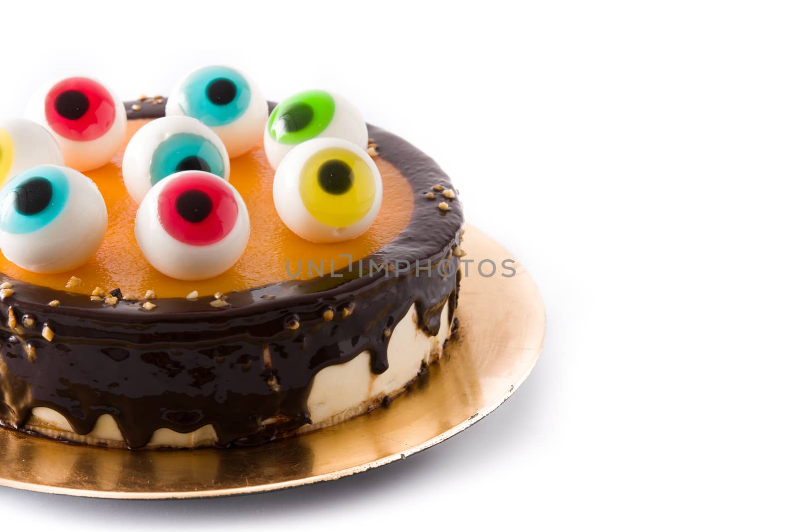 Halloween cake with candy eyes decoration isolated on white background.