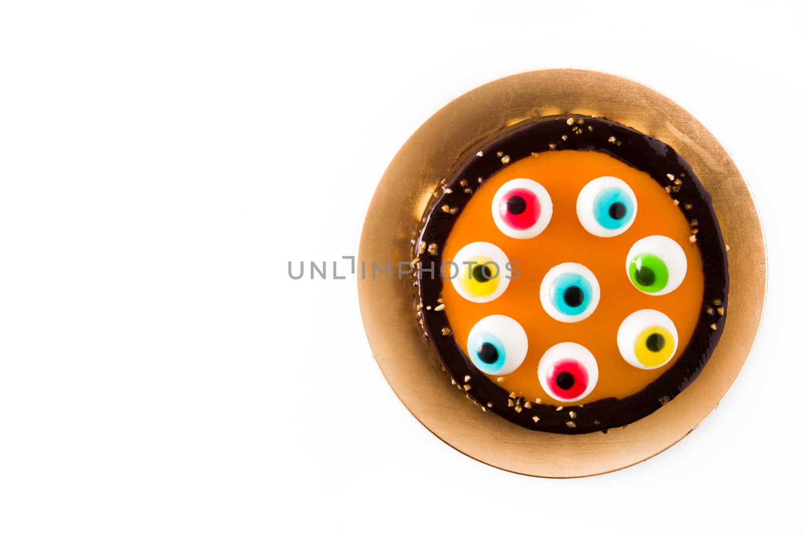 Halloween cake with candy eyes decoration isolated on white background.