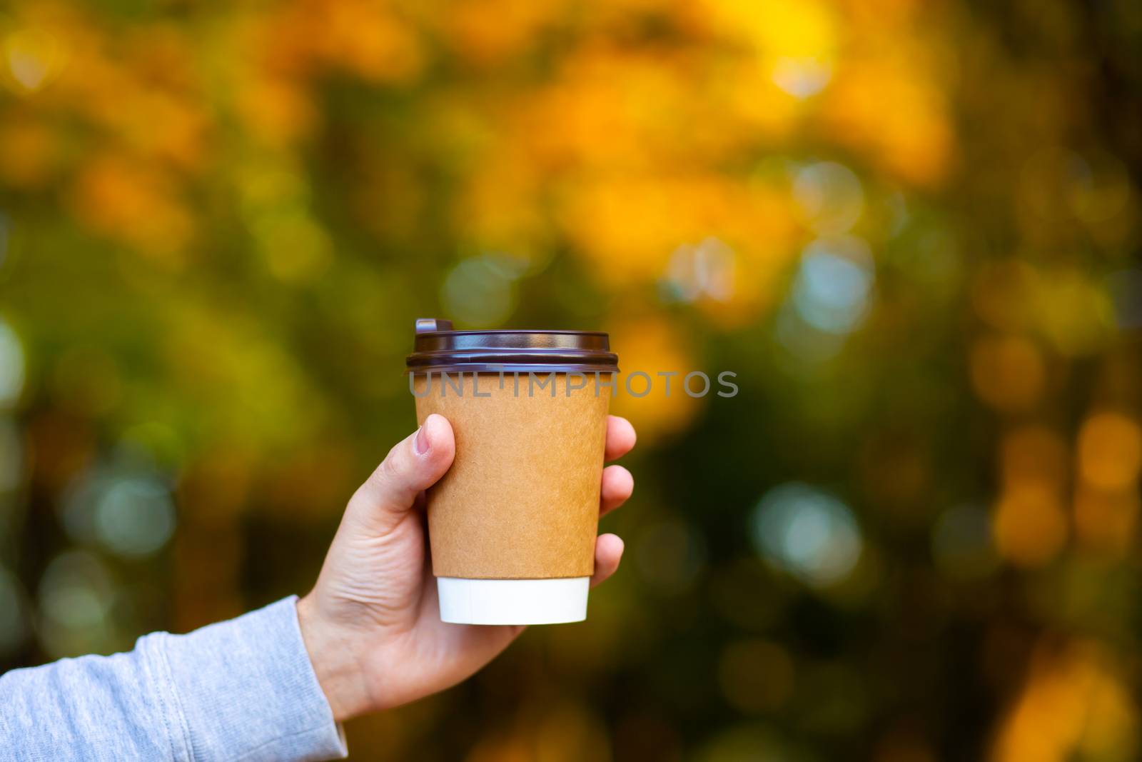 Walk with a cup of hot cocoa in the autumn park