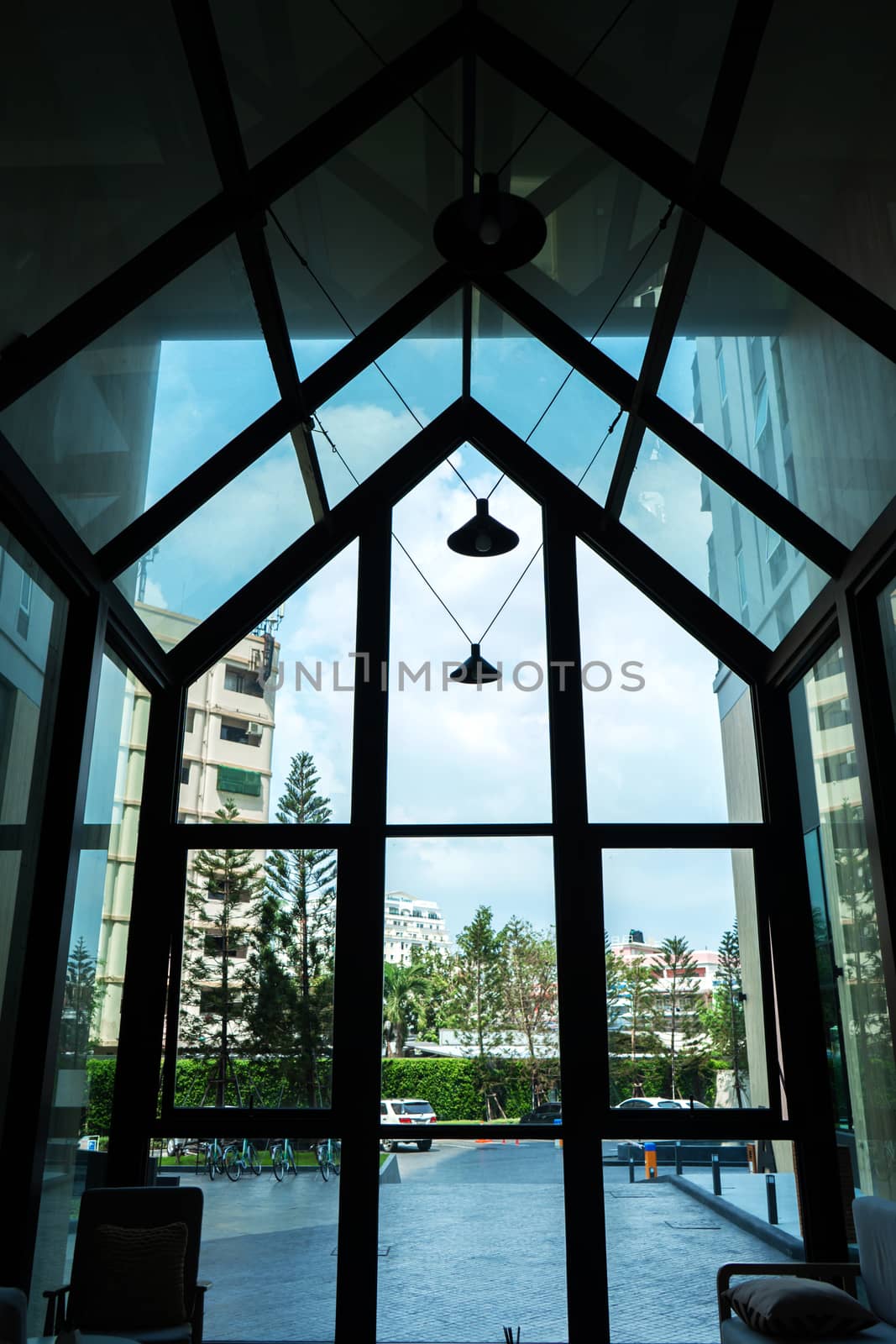 Glass construction in the shape of a house, a stylish lobby in a modern condominium