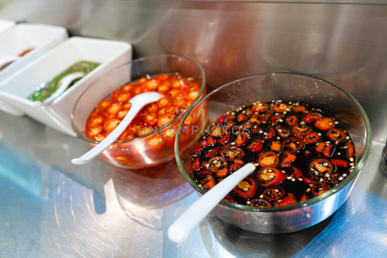 Street food market in Asia. Bowls with hot sauces of various types