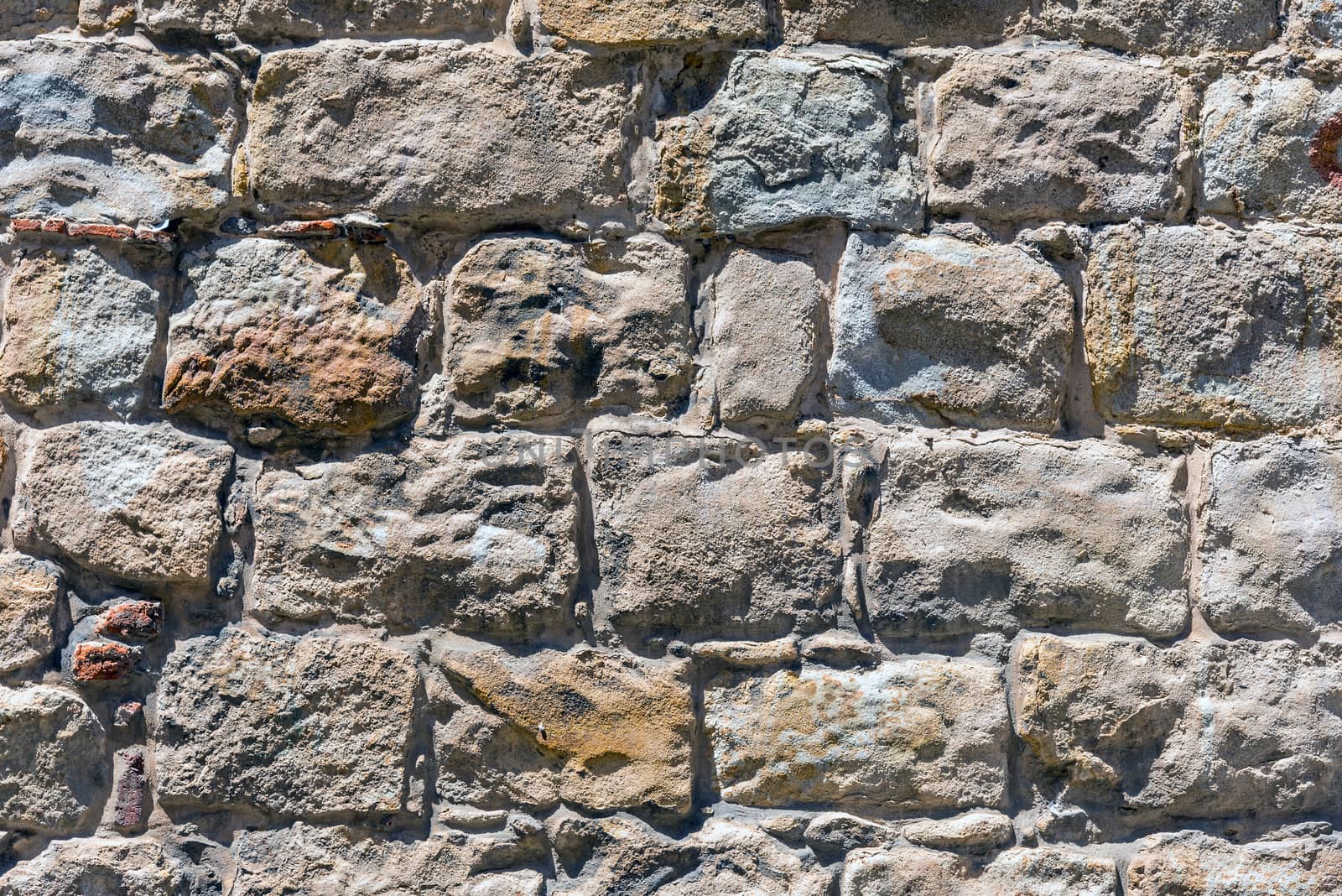 Rough brown natural stone wall by elxeneize