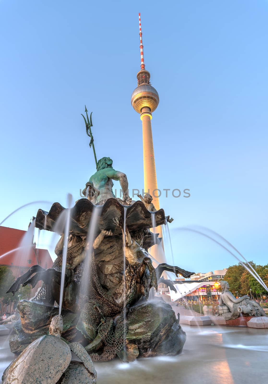 The Neptune fountain and the TV Tower in Berlin at twilight