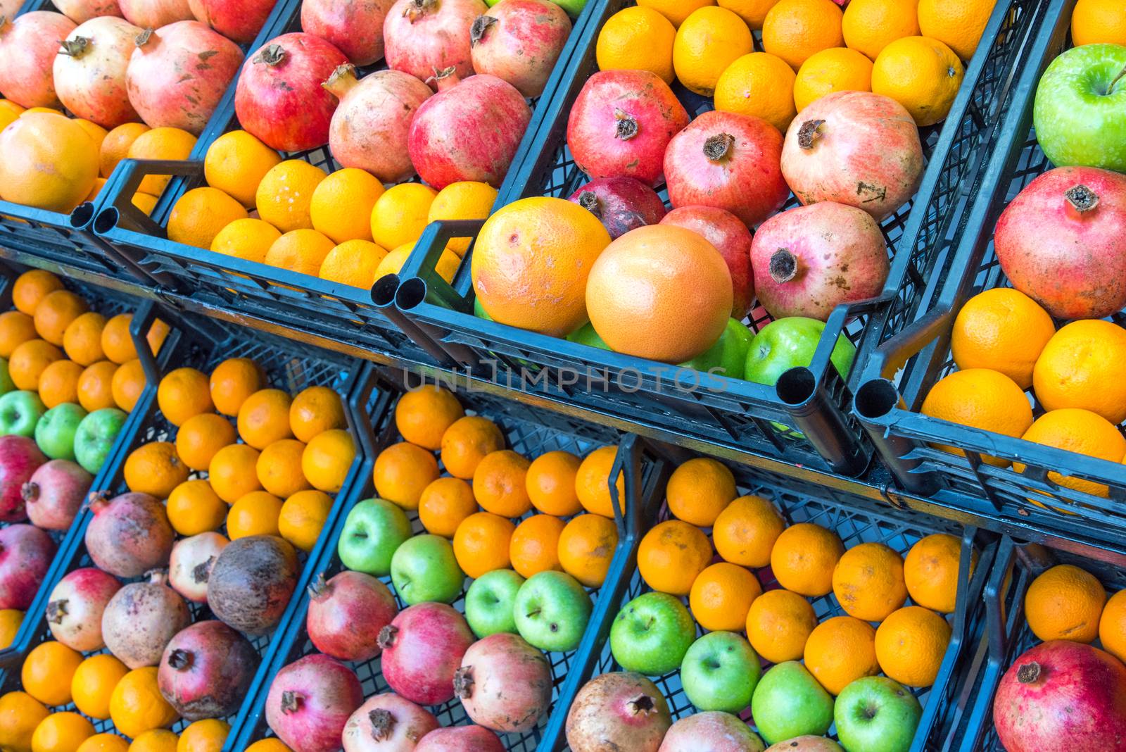 Pomegranates, apples and oranges for sale at a market