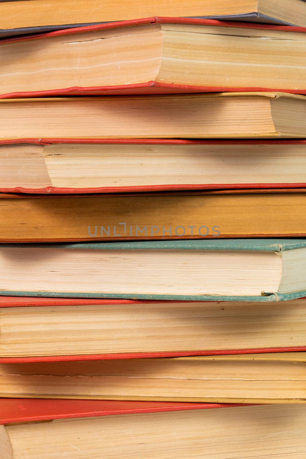 abstract books background - old red and muted green ones in a vertical stack.