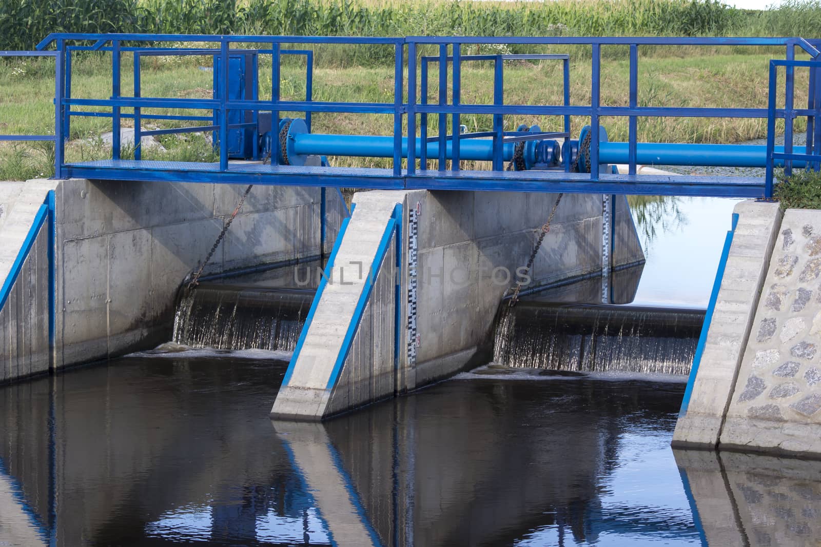 The railing and sluice regulate the water.