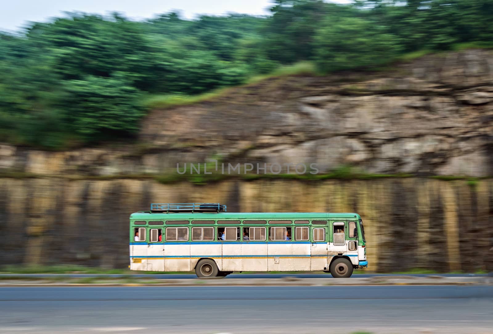 Isolated , slow shutter speed panning image of a speeding bus on highway.