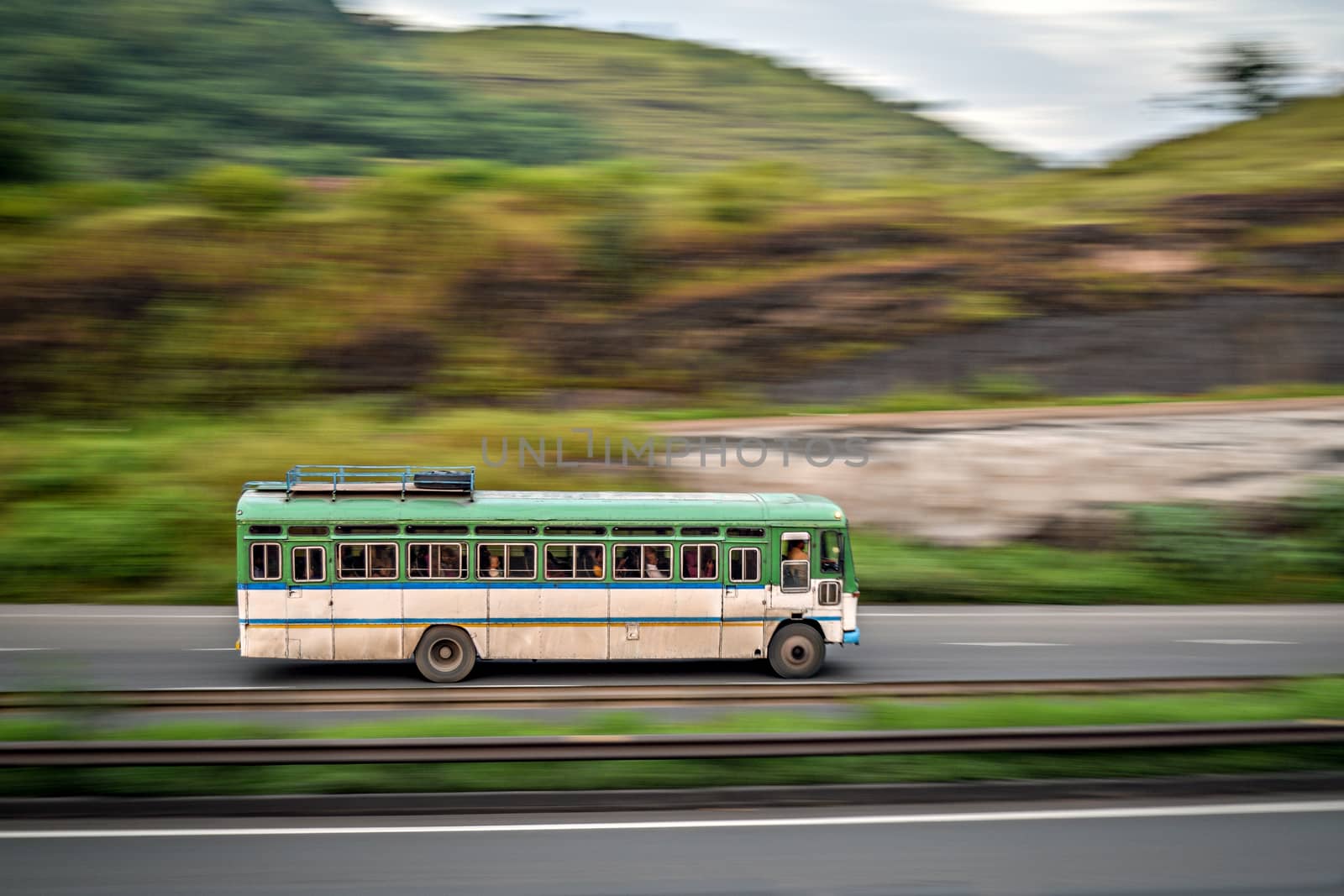 Isolated , slow shutter speed panning image of a speeding bus on highway.