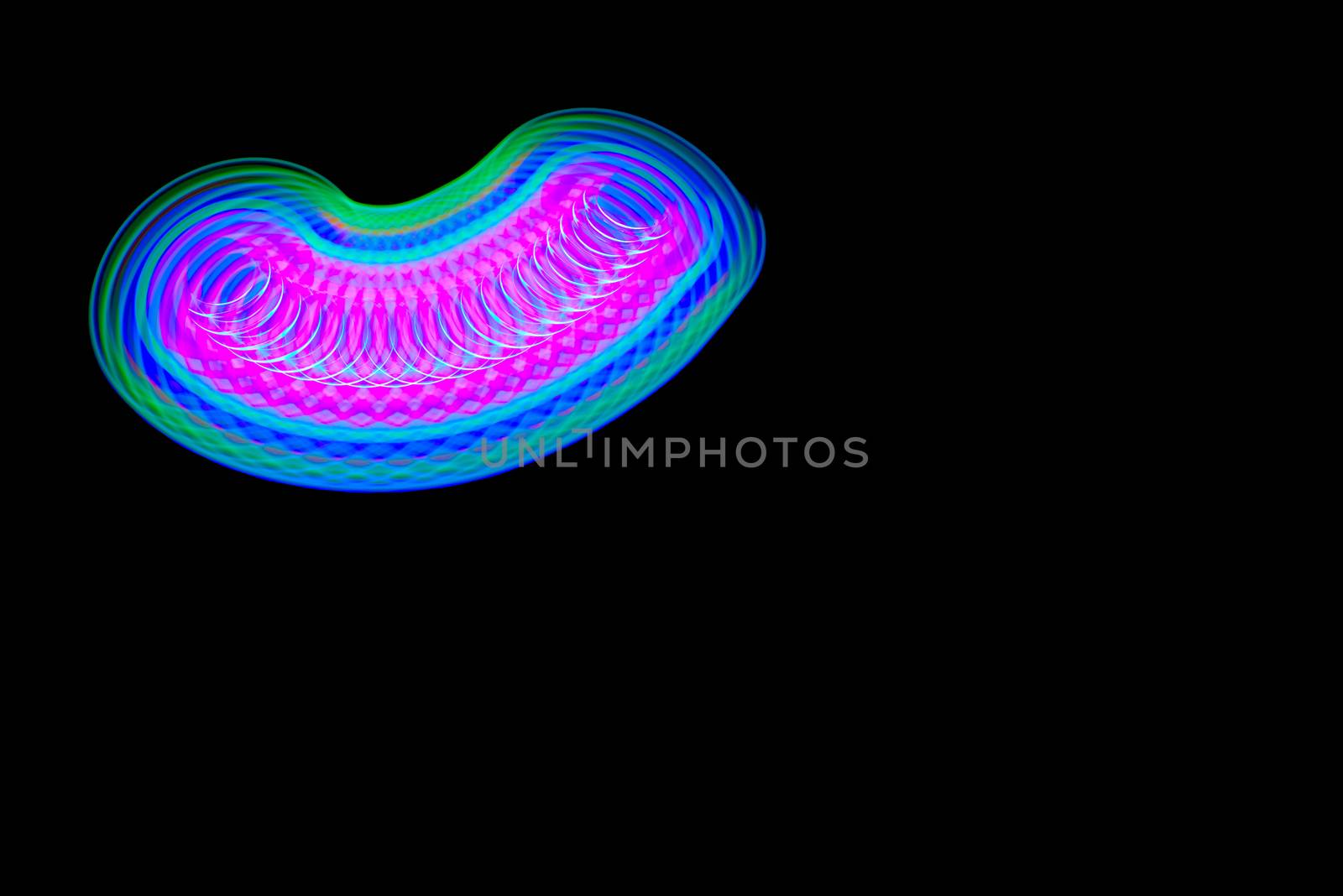 Long exposure photograph of a light spinning top with black background. by lalam