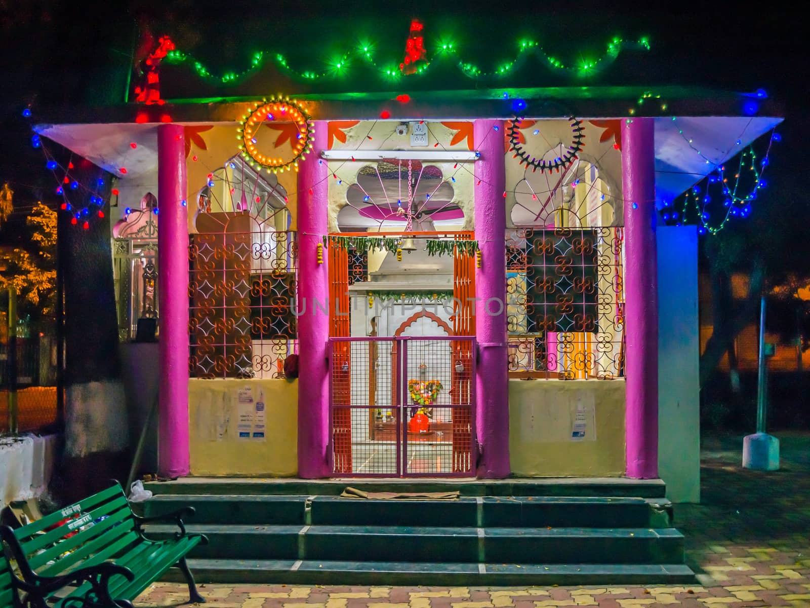 Decorated temple of Lord Hanuman with lighting series at night.