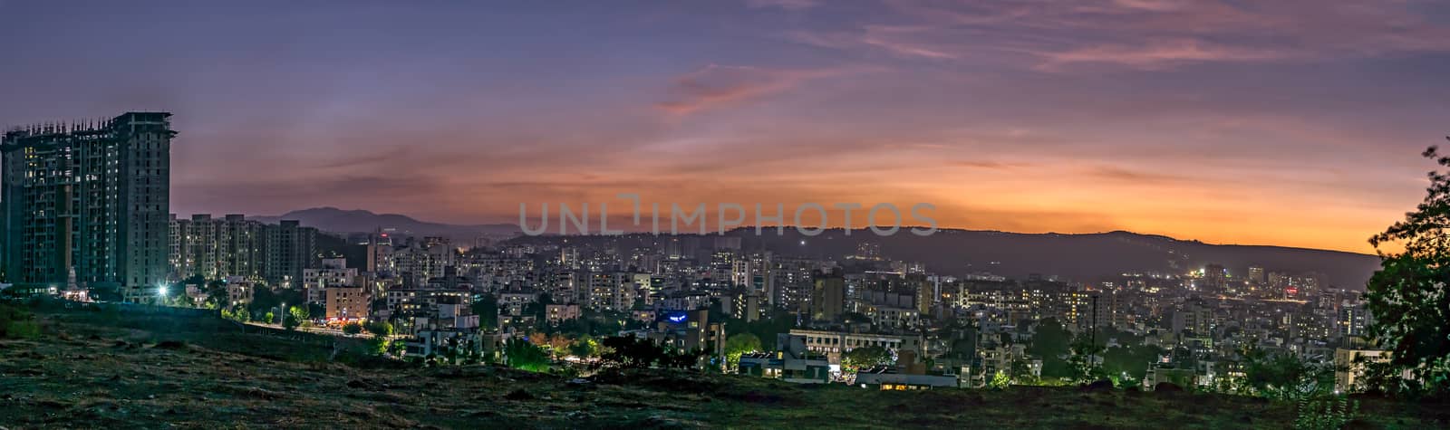Panorama image of beautiful evening sky in the city with some lights in buildings. Can be used as background. by lalam