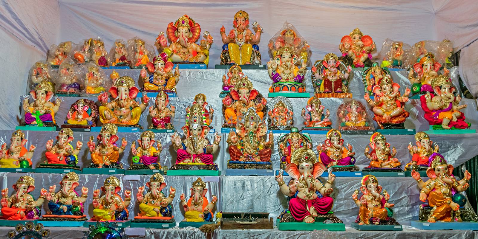 Colorful clay made idols of Hindu god Lord Ganesha ready for sale at a stal by lalam