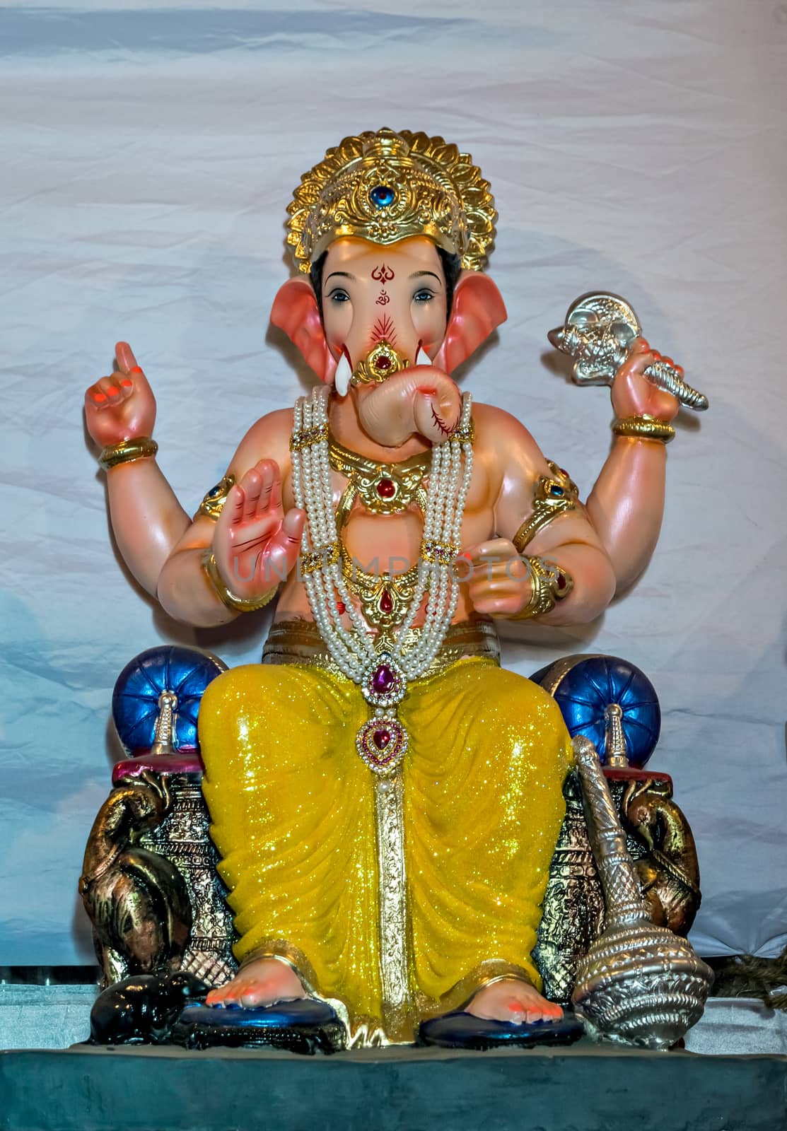 Freshly made, painted, hand crafted clay idol of Hindu god Lord Ganesha. by lalam