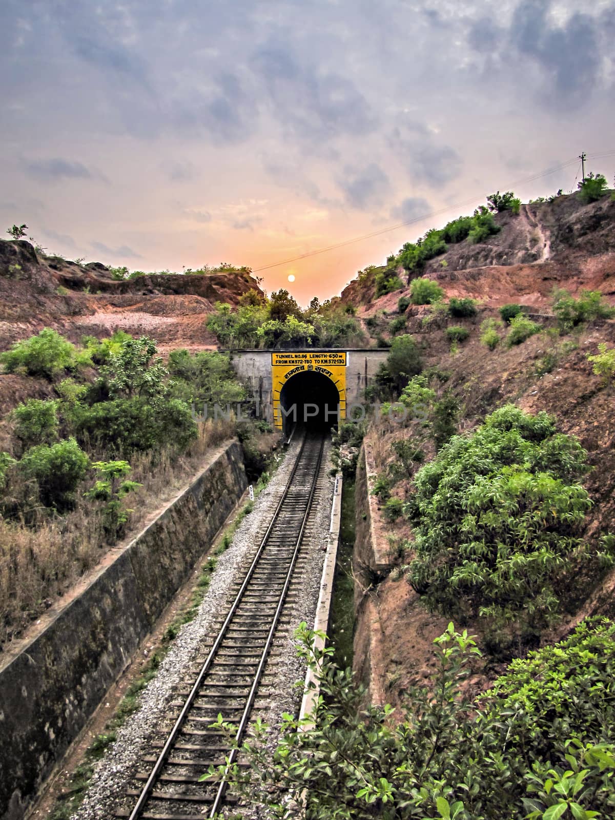 Sunset over the railway line going into tunnel at Honavar, Karnataka. by lalam