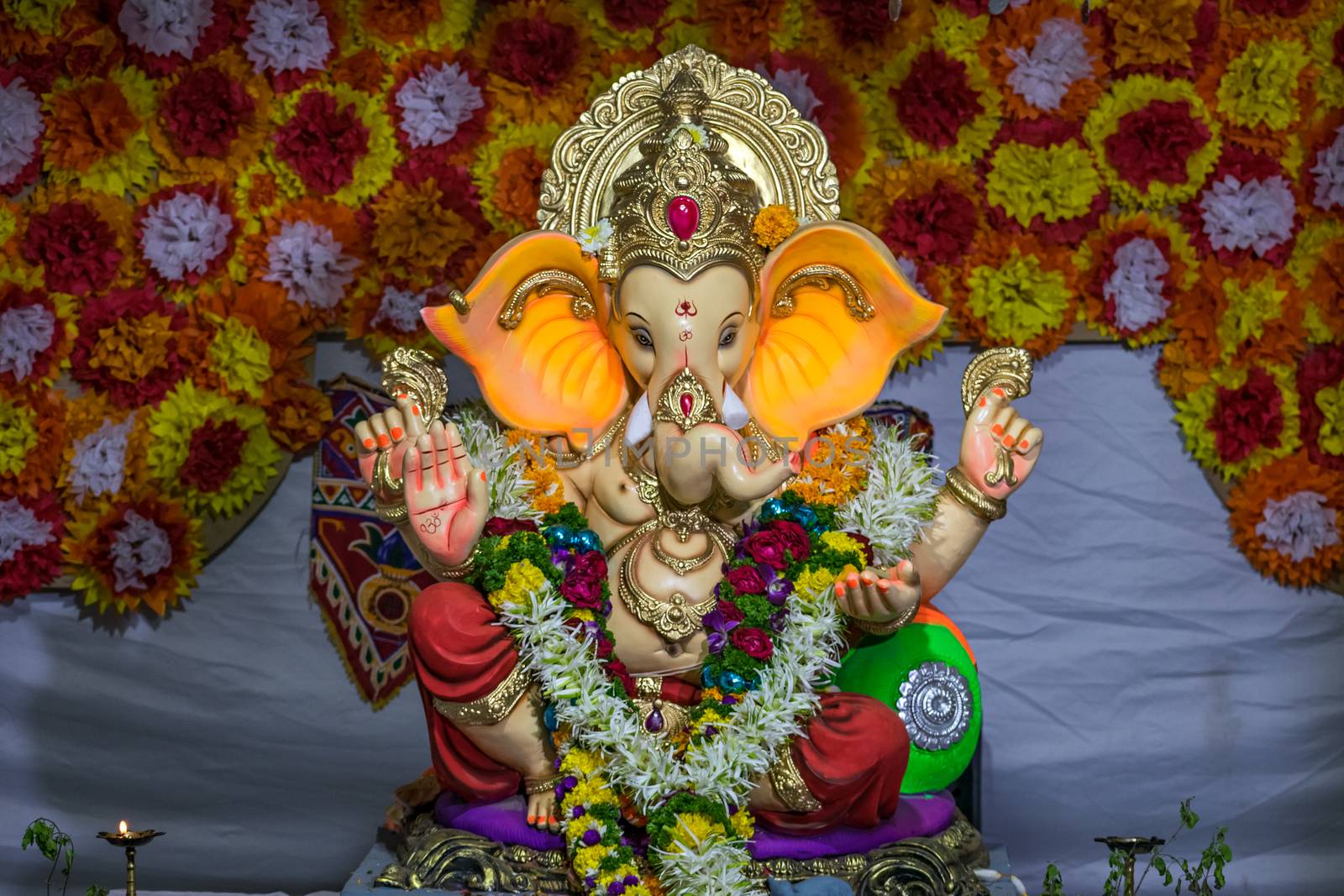 Decorated and garlanded  idol of Hindu God Ganesha in Pune ,Maharashtra, India. by lalam