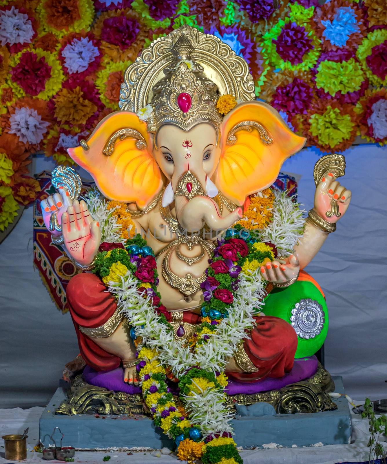 Portrait , closeup view of decorated and garlanded  idol of Hindu God Ganesha in Pune ,Maharashtra, India.