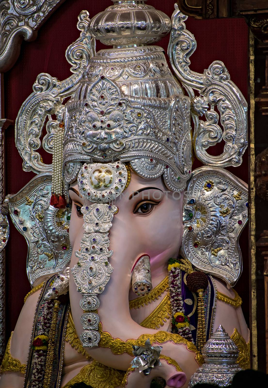 Close up portrait view of decorated and garlanded  idol of Hindu God Ganesha in ulshibaugPune ,Maharashtra, India. by lalam