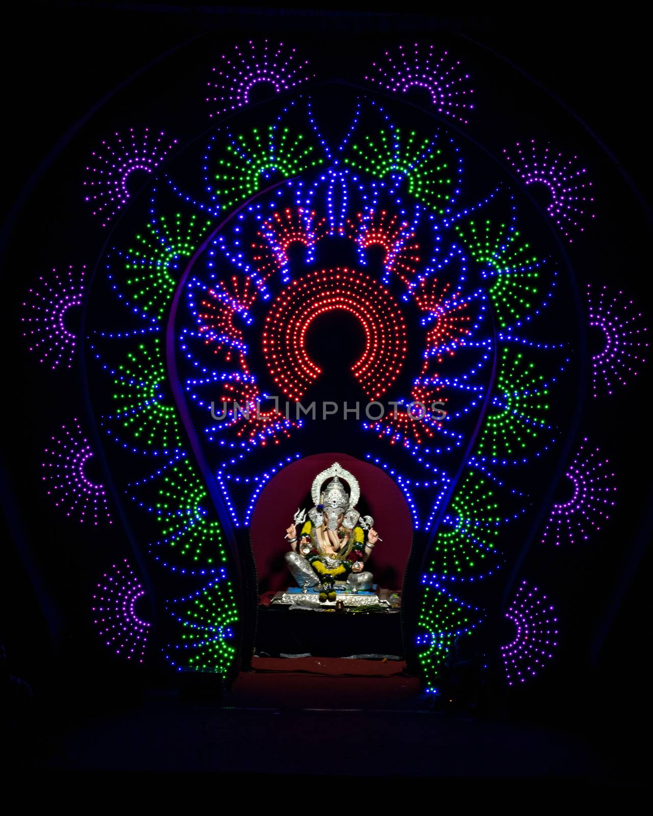 Close up , portrait view of lighting and decorated and garlanded Isolated idol of Hindu God Ganesha in Pune ,Maharashtra, India.