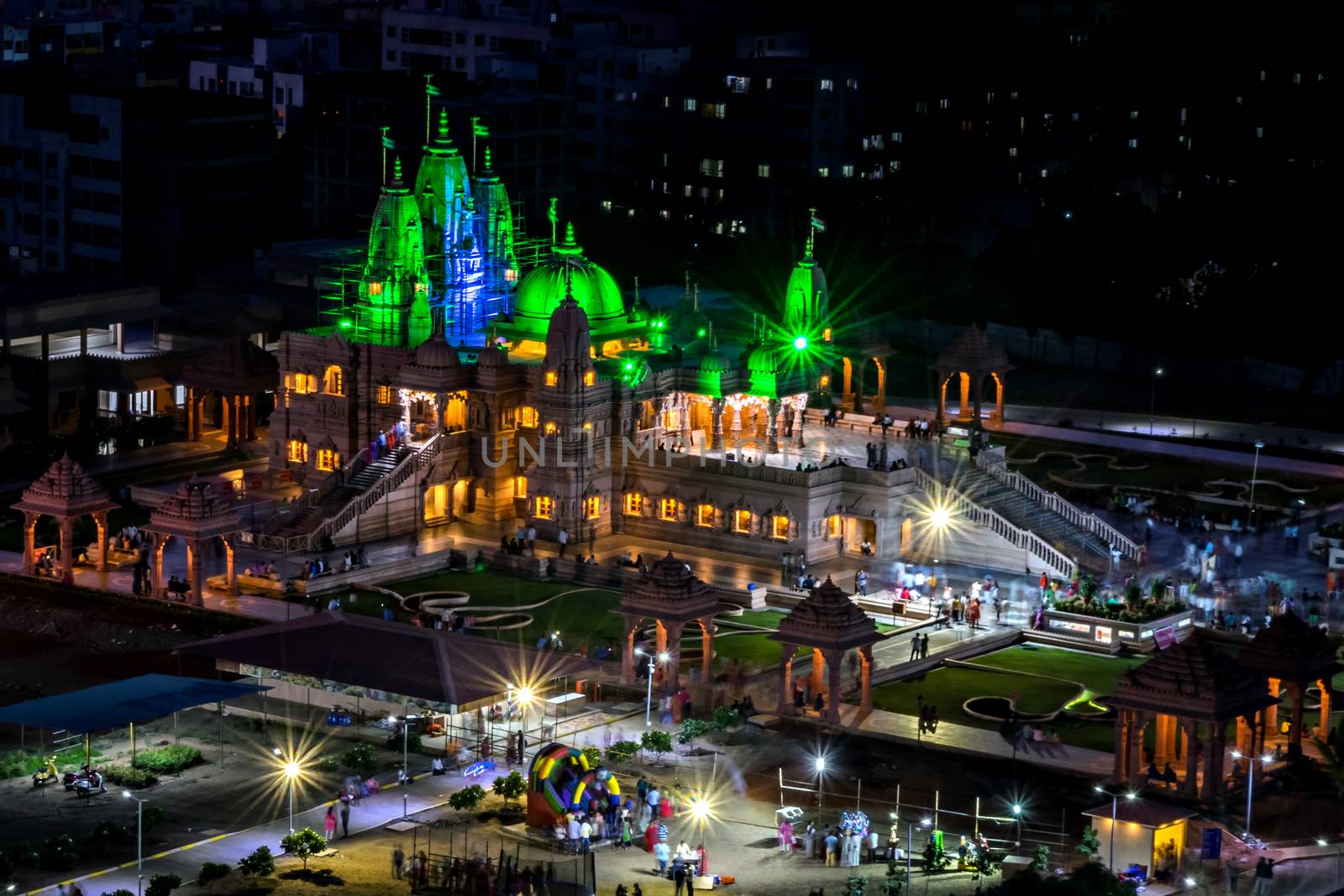 Night view of Shree Swaminarayan temple lit with green lights  in Pune. This is an excellent newly built temple located just down the hill. Lot of green landscape around the temple. A spacious place with lot of parking lot. Lot of Hindu festivals are celebrated here with decorations. Lighting during night is also awesome.