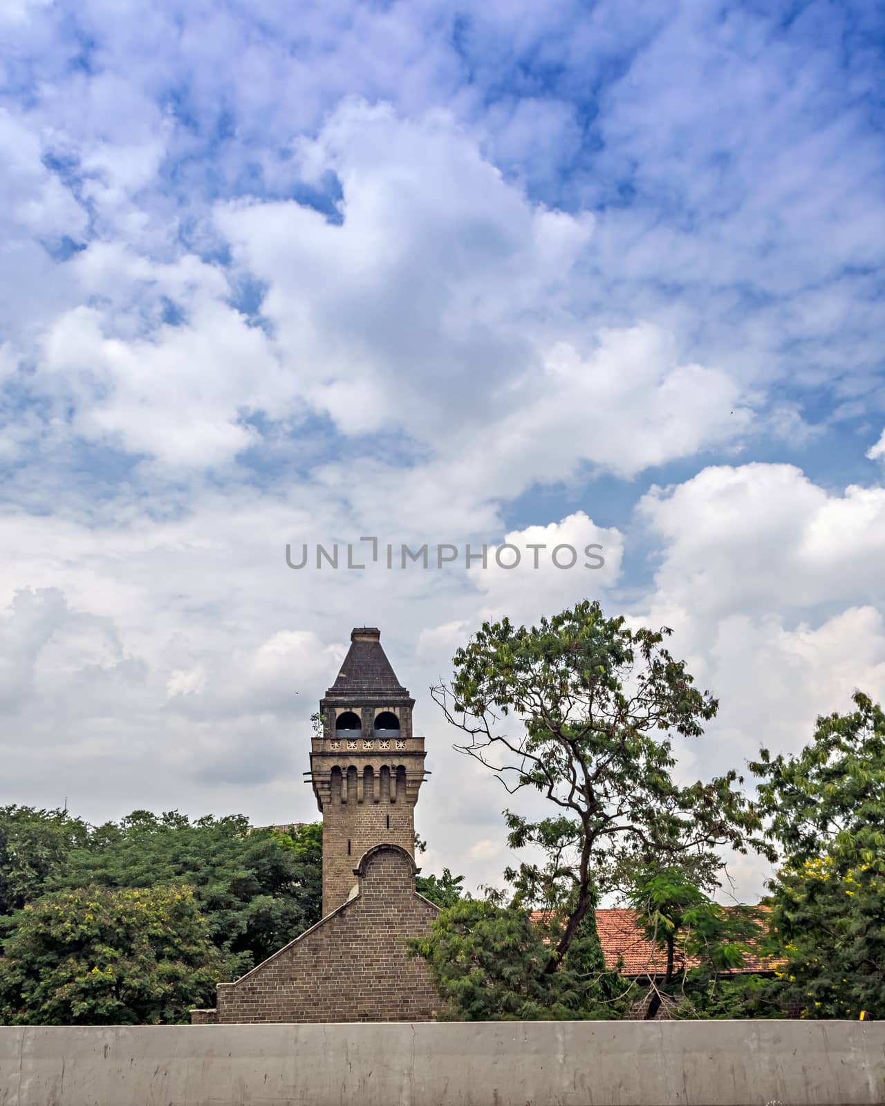 Nice clouds and blue sky over ancient dome of college of Engineering Pune, Maharashtra, India. by lalam