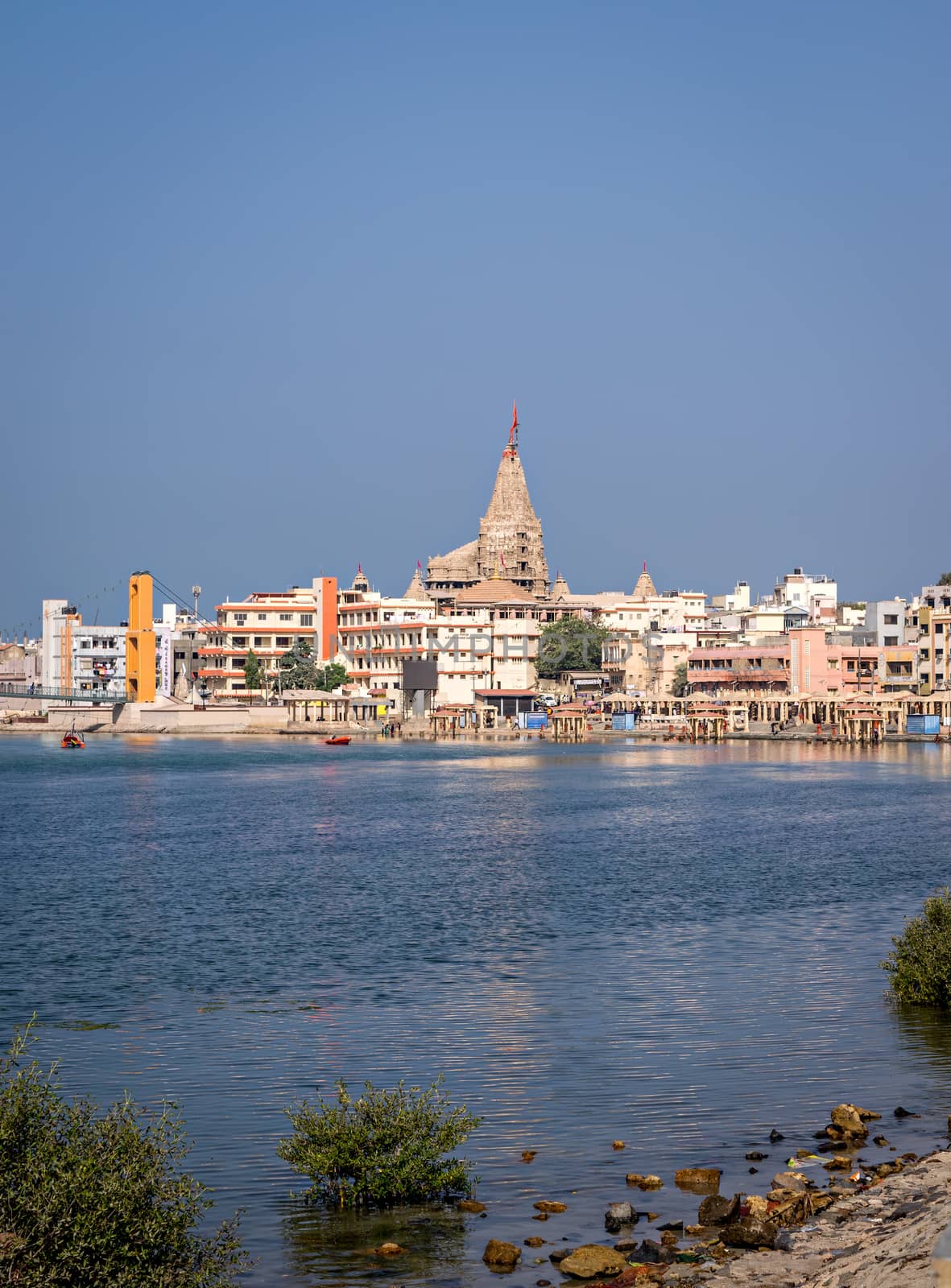 Gomathi ghat and view of  Dwarkadheesh temple in Gujrat, India with clear blue sky.