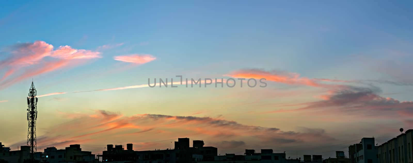 Panorama image of beautiful evening sky in the city. Can be used as background. Light of evening sky colors. by lalam