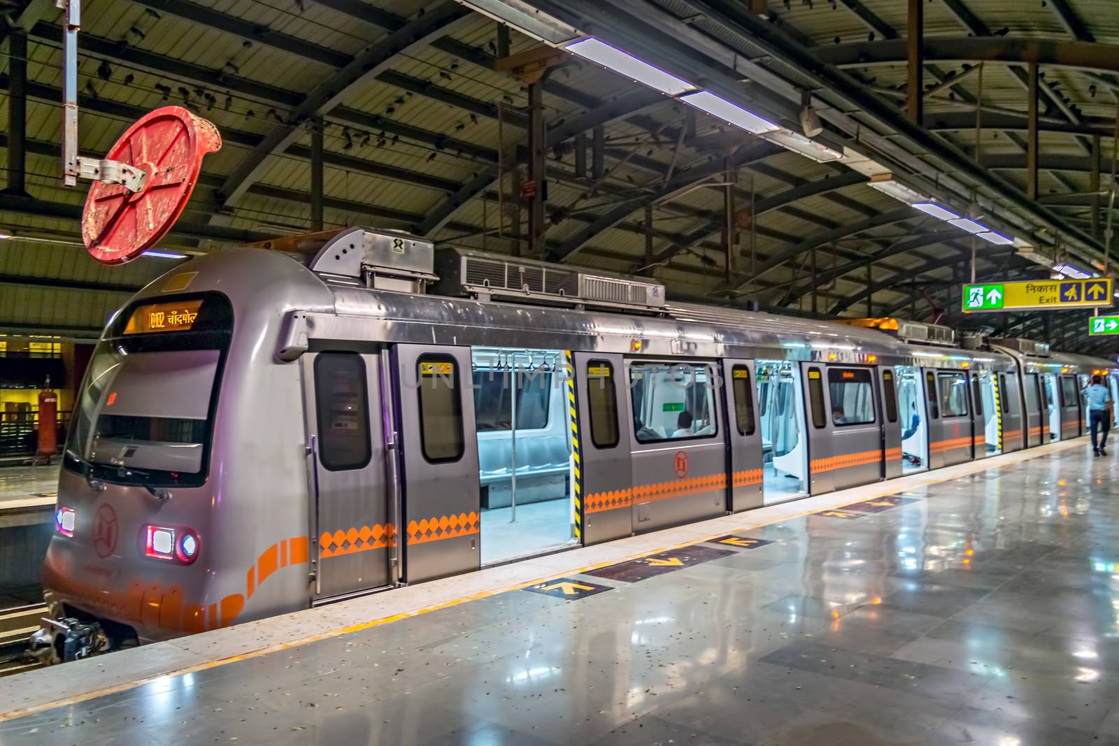 Close up of colorful rapid transit metro train entering Jaipur junction station in the morning.