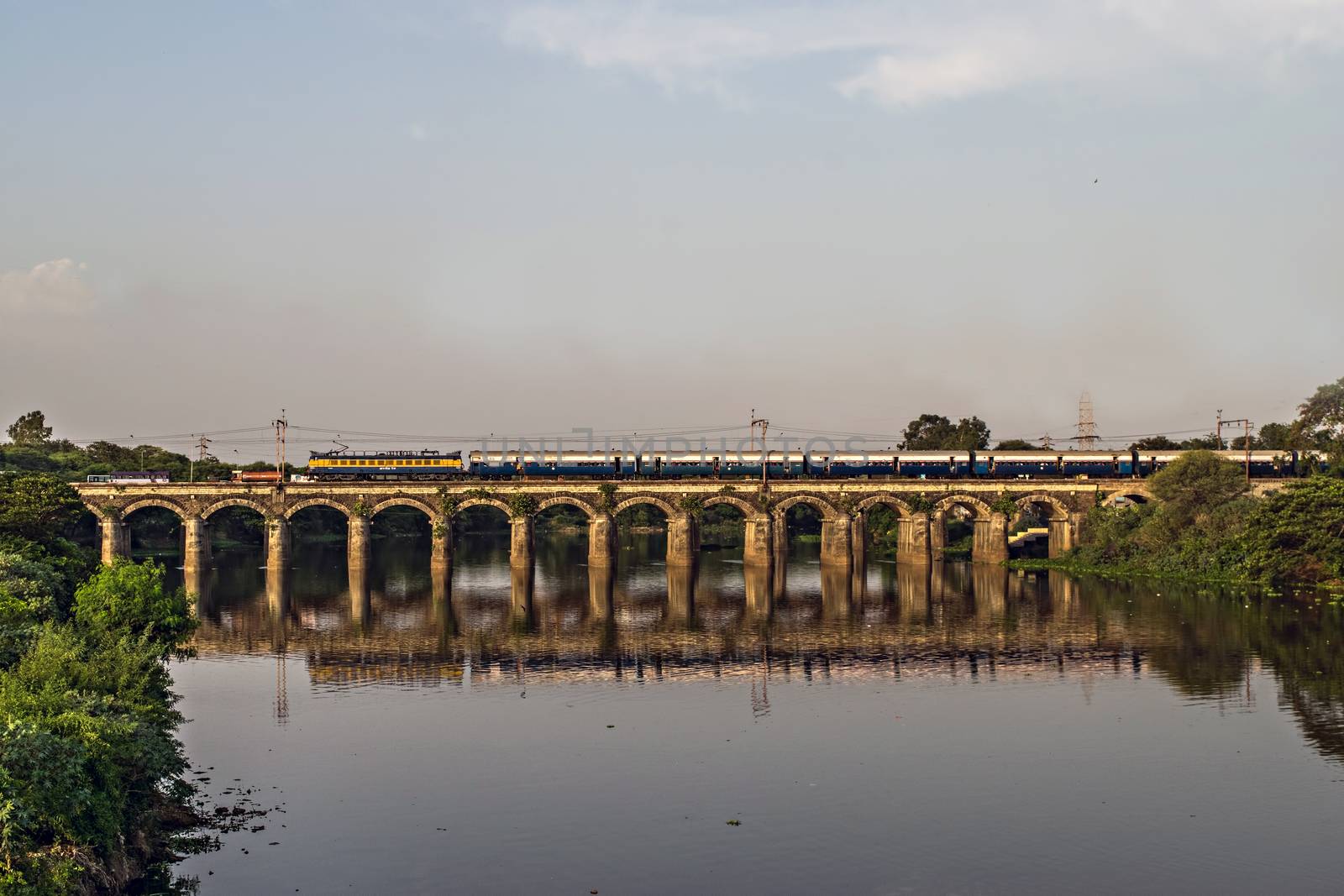 Pune to Mumbai super fast Intercity express train passing over Harris bridge in Dapodi, making a nice reflection in waters of Mula river. by lalam