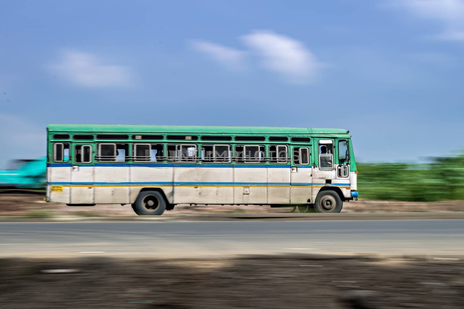 Motion blur image of non air-conditioned intercity bus in Maharashtra, speeding on the street.  India. by lalam