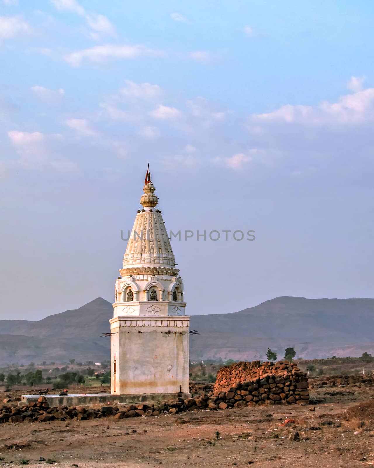 Isolated image of a small temple outside Tarde village in Pune district of Maharashtra, India. by lalam