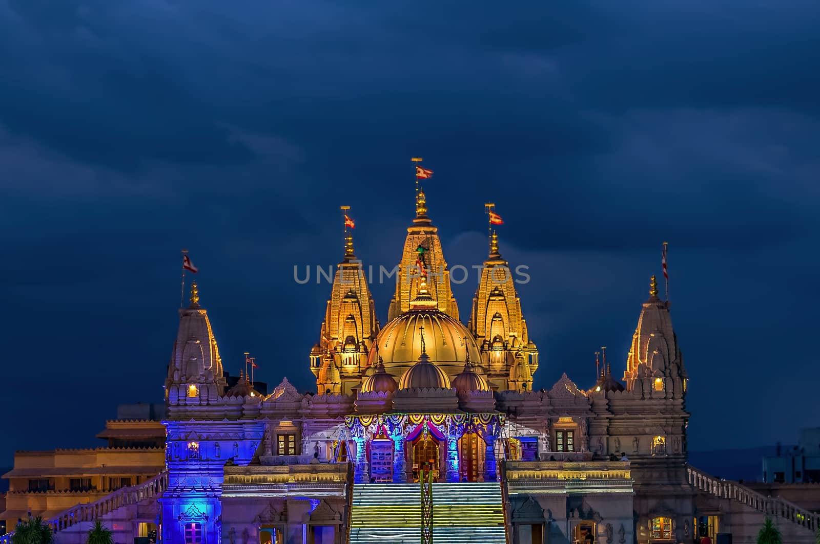 Lighted image of Shree Swaminarayan temple with monsoon clouds background, Ambe Gaon,  Pune . by lalam