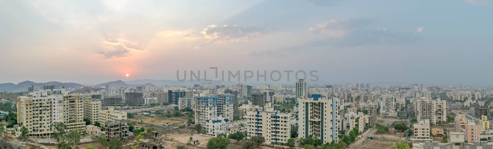 Sunset in a fast growing city with tall buldings. by lalam