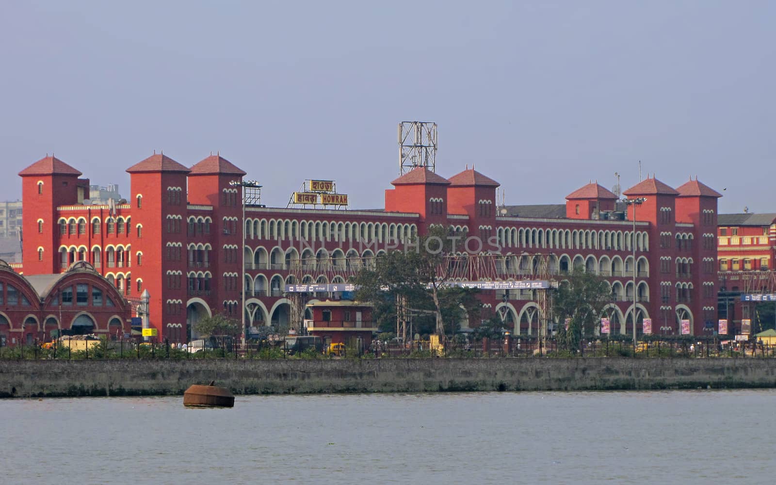 View of historical Howrah railway station building from across the Hooghly river in Kolkata.