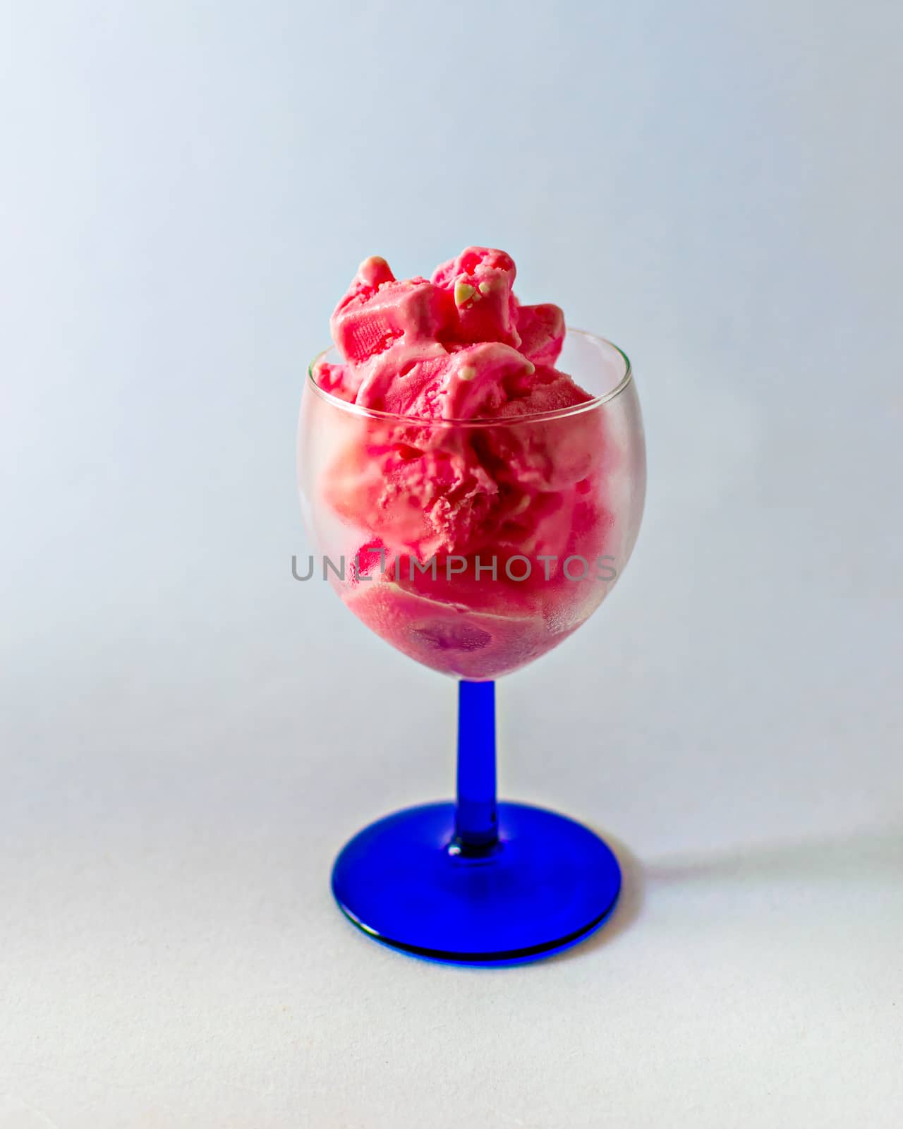 Delicious, pink strawberry ice-cream in a tranparent wine glass. by lalam