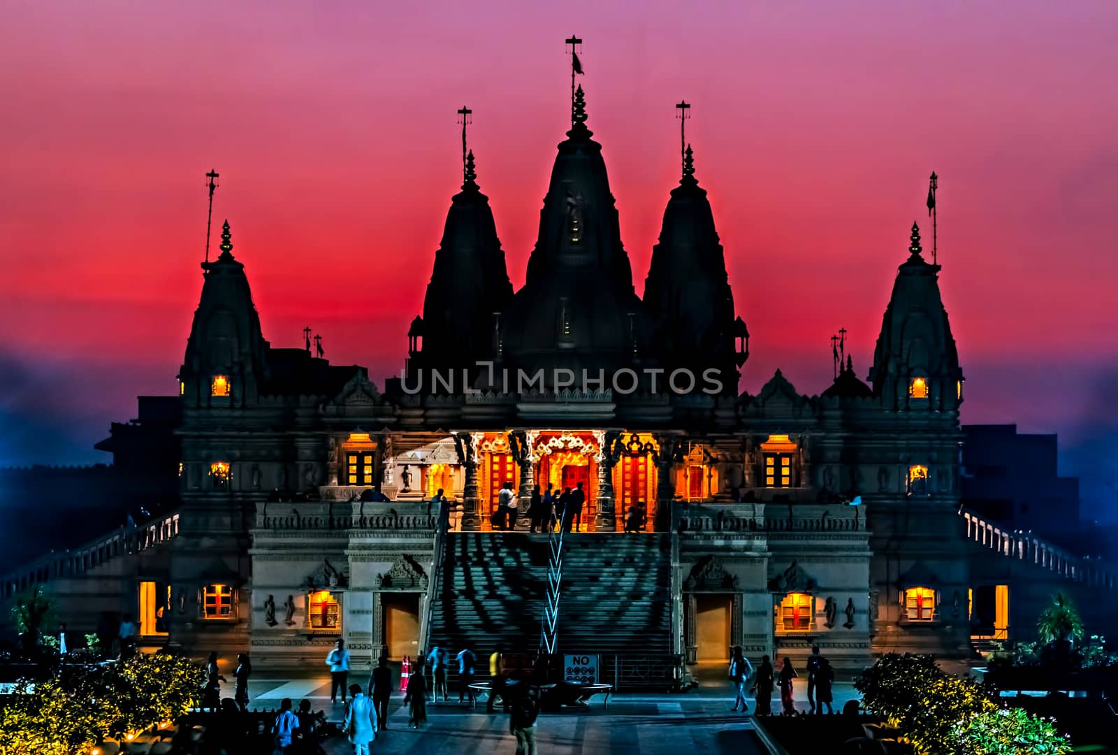 Silhoutte image of Shree Swaminarayan temple on orange sky backg by lalam