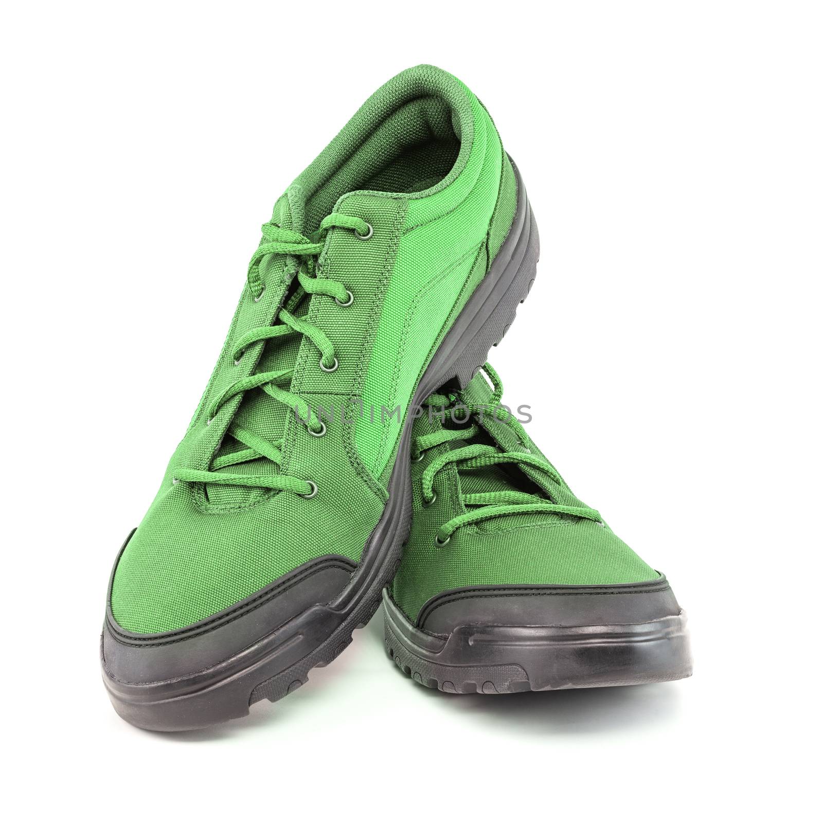 a pair of light green hiking shoes isolated on white background - perspective close-up view.