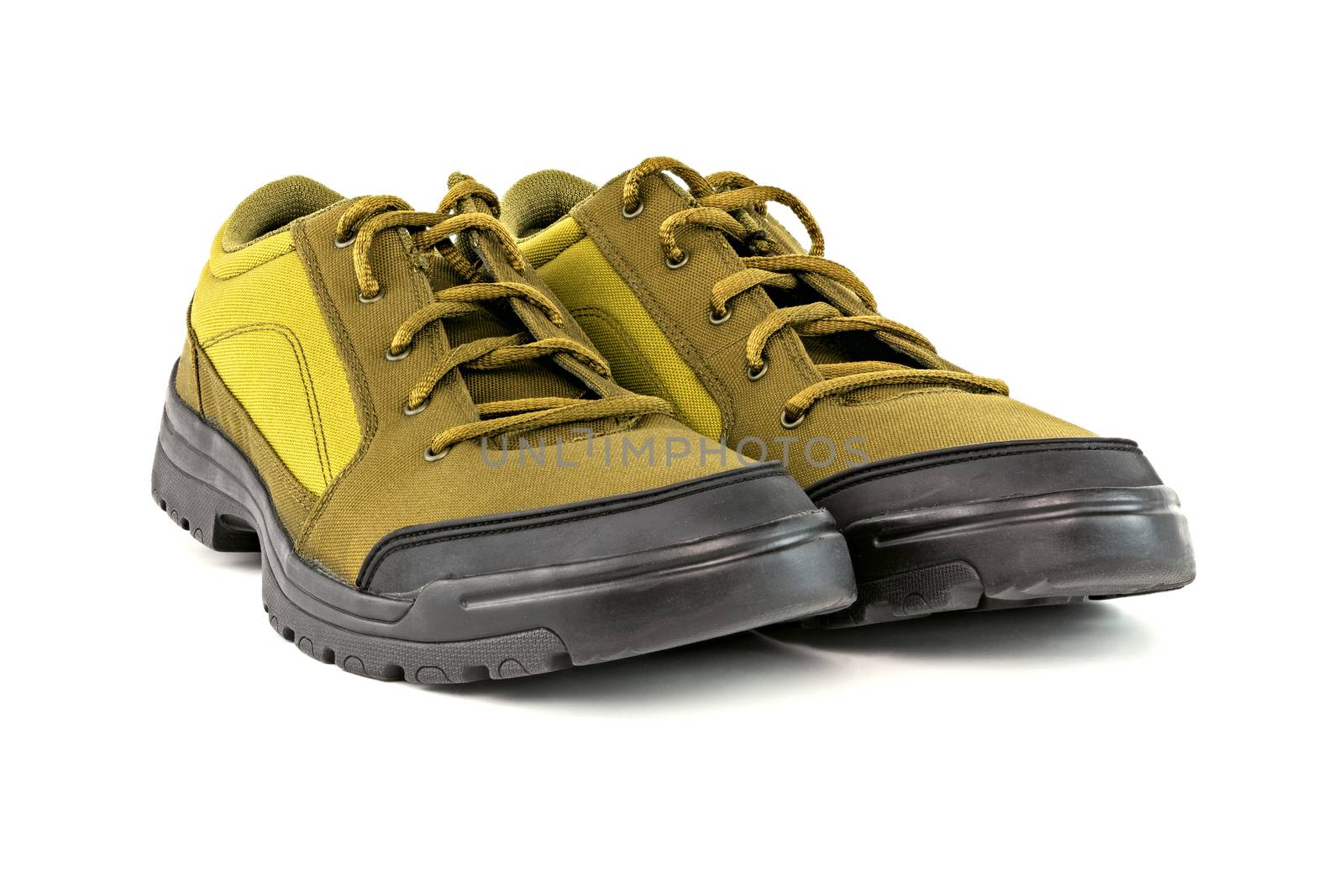 a pair of cheap yellow dense fabric fabric hiking or hunting shoe isolated on white background.