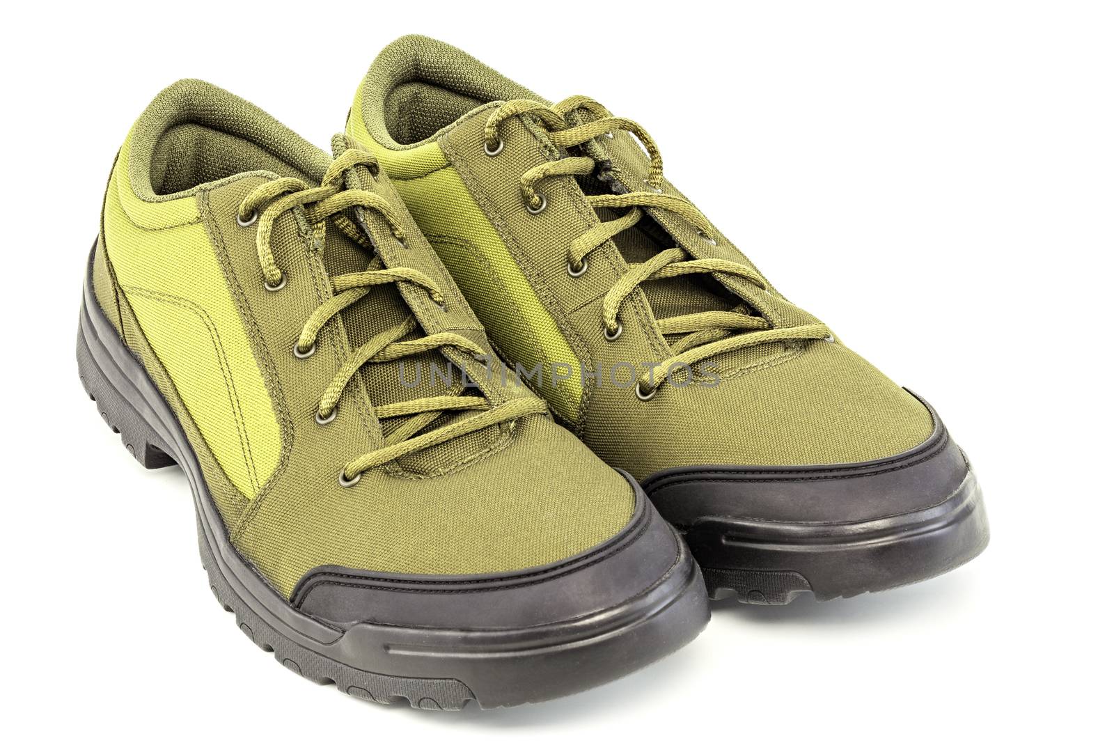 a pair of cheap yellow dense fabric fabric hiking or hunting shoe isolated on white background.