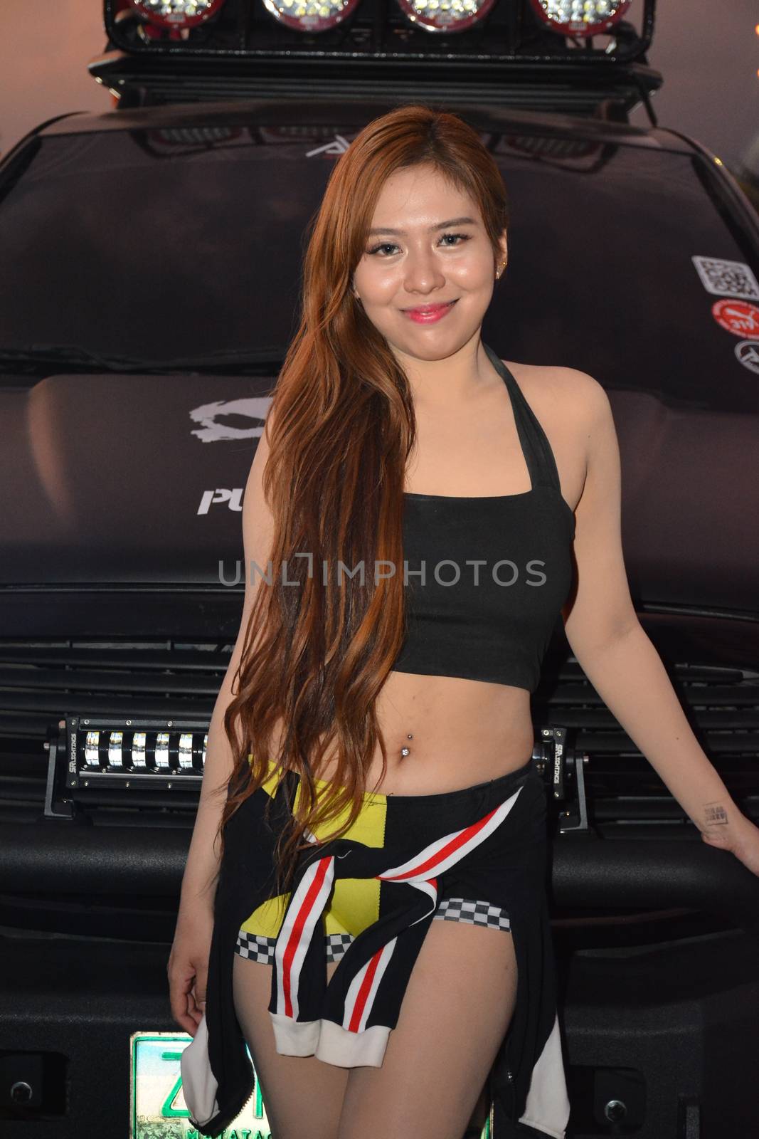 PASAY, PH - DEC. 7: Car show female model at Bumper to Bumper 15 on December 7, 2019 in Mall of Asia Concert Grounds, Pasay, Philippines. Bumper to Bumper is a annual aftermarket car show event in the Philippines.