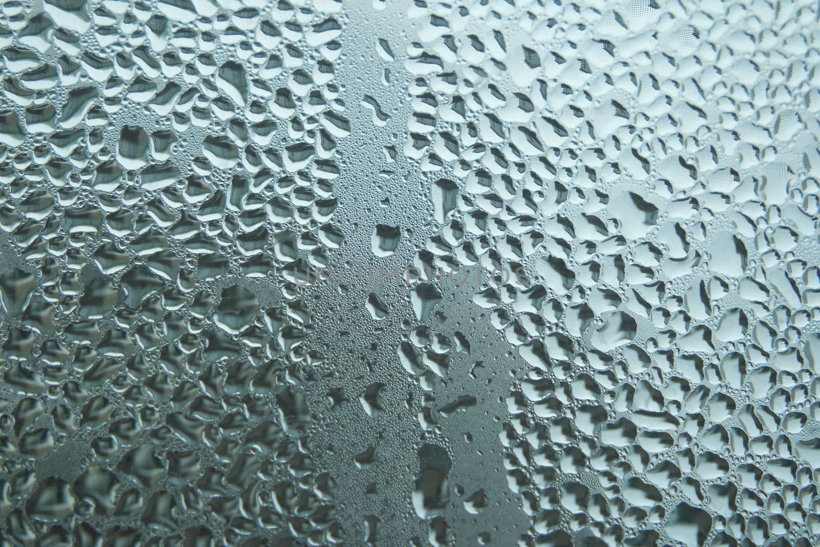 Bright grey color glassy texture, with water drops on it. Water drop glassy background