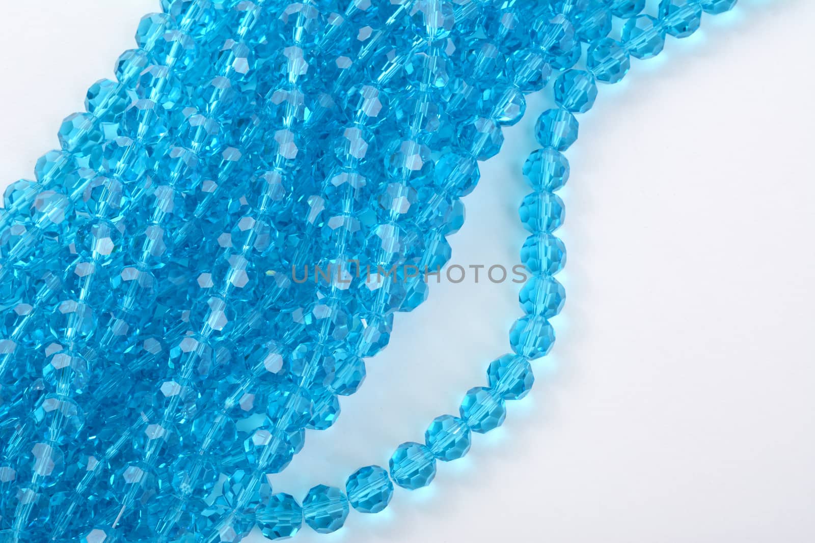 Beautiful Light Blue Glass Sparkle Crystal Isoalted Beads on white background. Use for diy beaded jewelry. Space for text