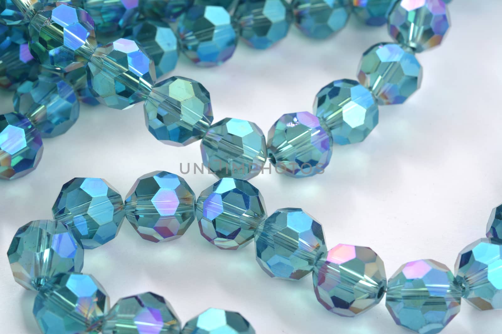 Beautiful Light Blue Glass Sparkle Crystal Isoalted Beads on white background. Use for diy beaded jewelry. Space for text