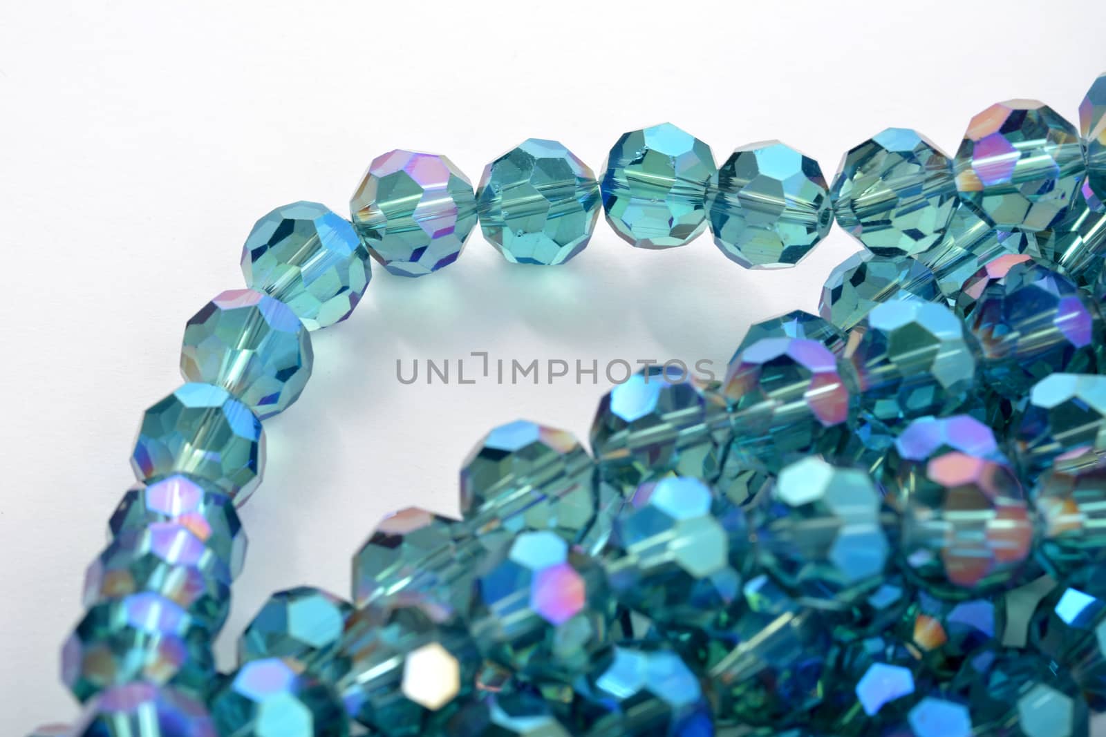 Beautiful Light Blue Glass Sparkle Crystal Isoalted Beads on white background. Use for diy beaded jewelry. Space for text